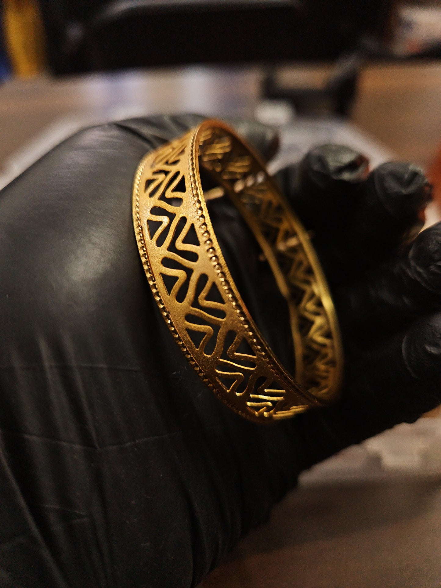 Gold plated shiny cut design bangle